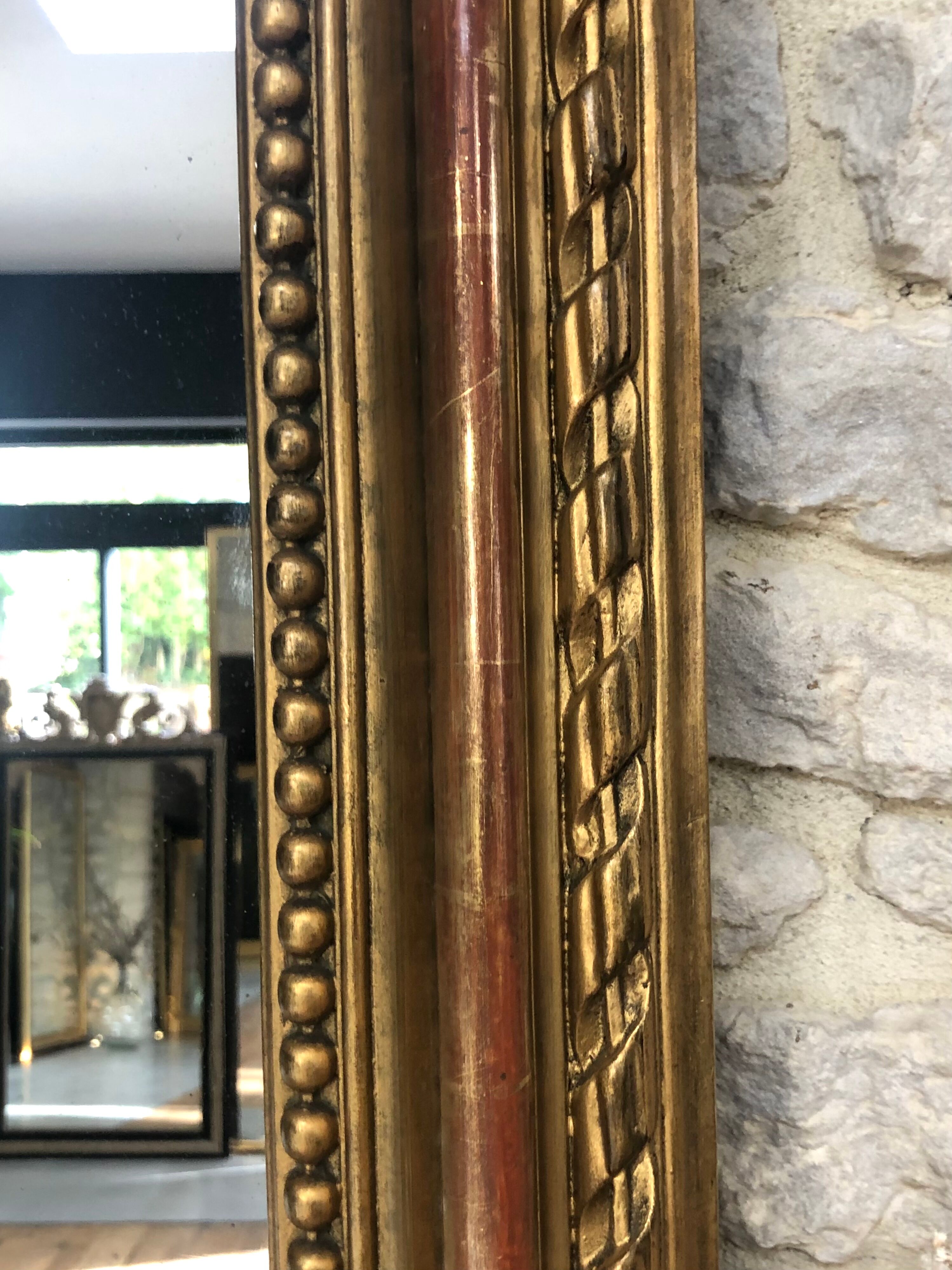 Old mirror 139cm/ 91cm Louis-Philippe with pediment period early 19th, presence of gold leaf.