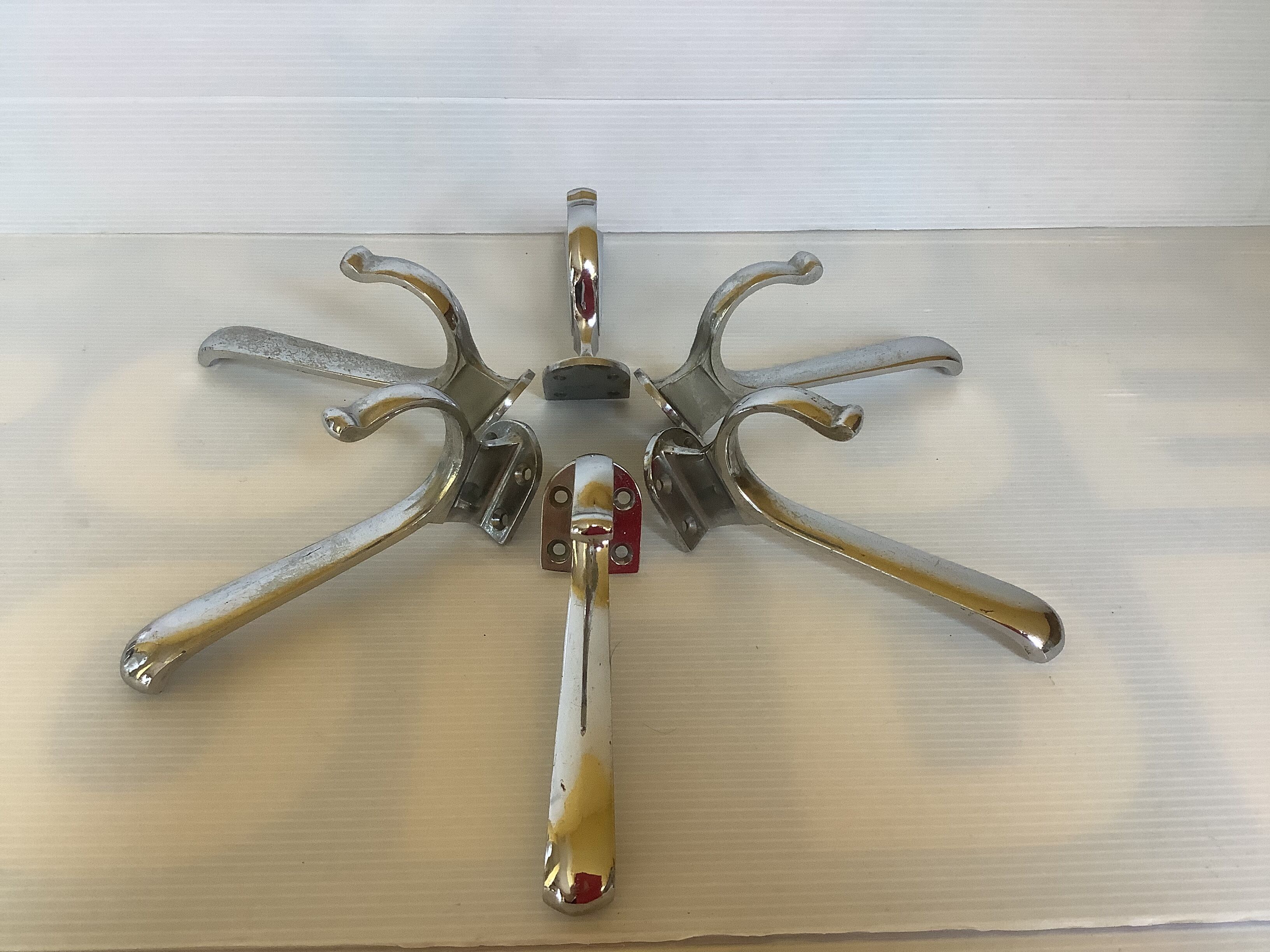 Six old chrome-plated metal hooks