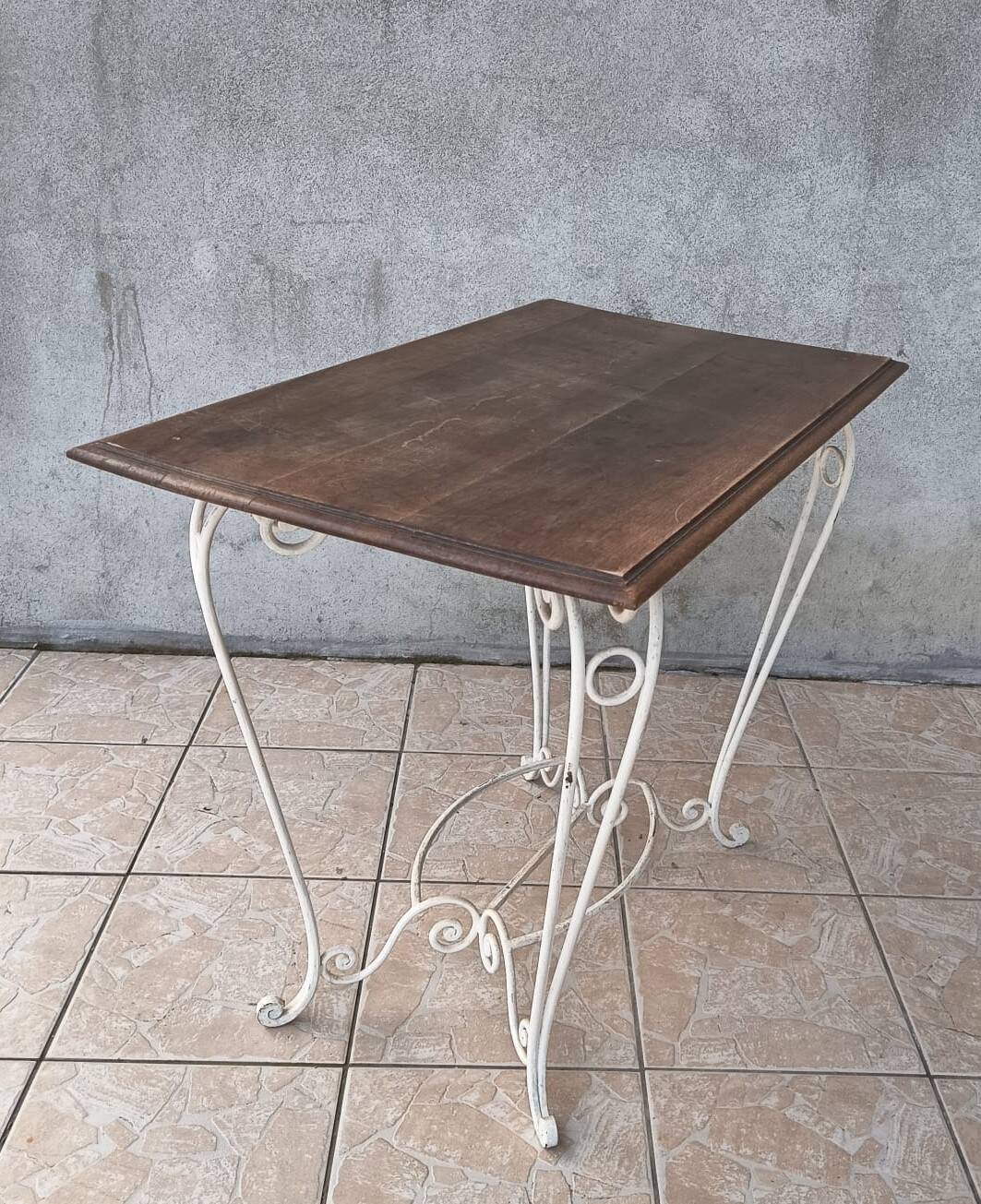 Wrought iron table with a walnut top.