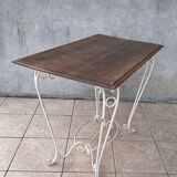 Wrought iron table with a walnut top.