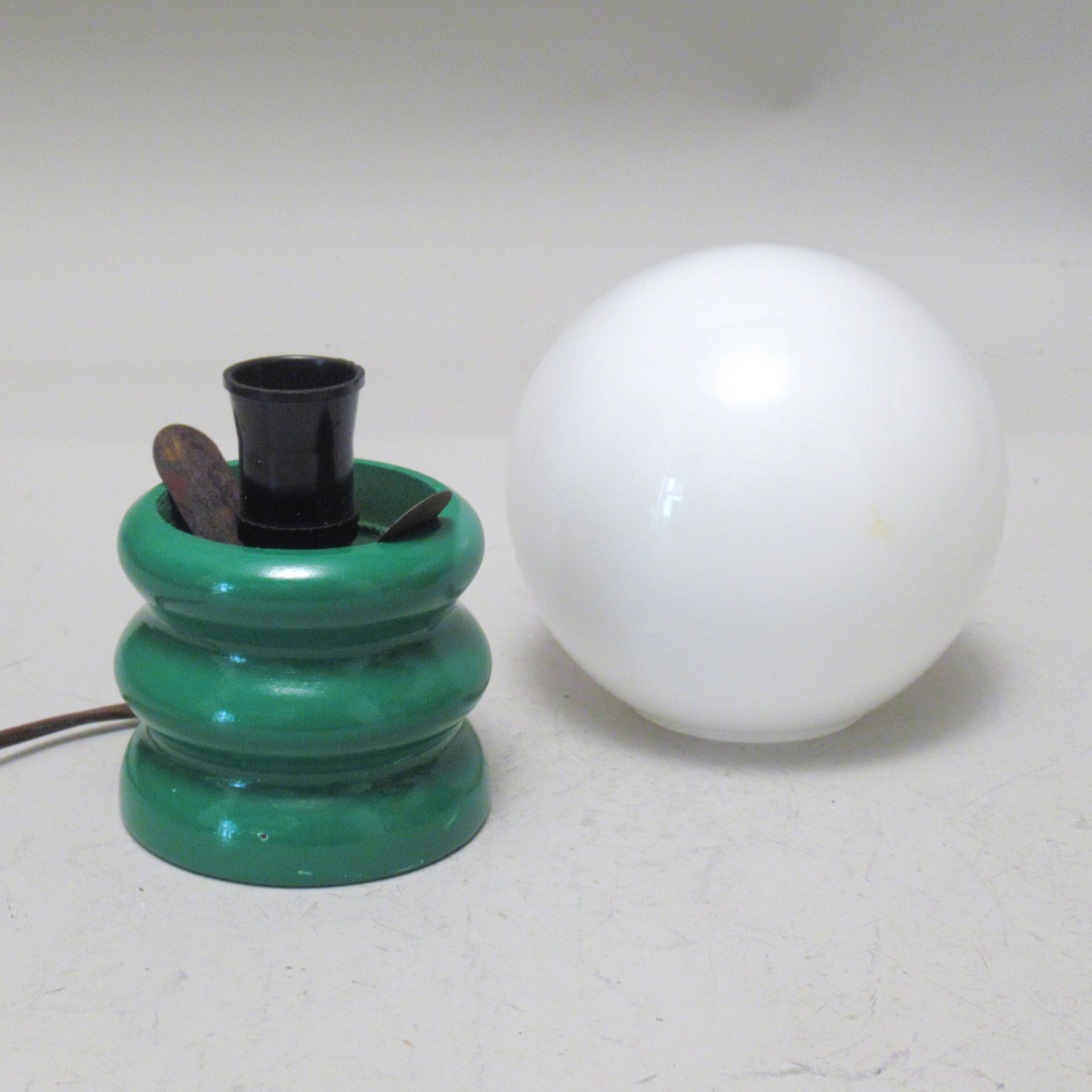 Green 1970s floor lamp with a globe shade.