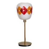 Table lamp with a vintage orange and red "Jacquard" globe in white glass and a golden base