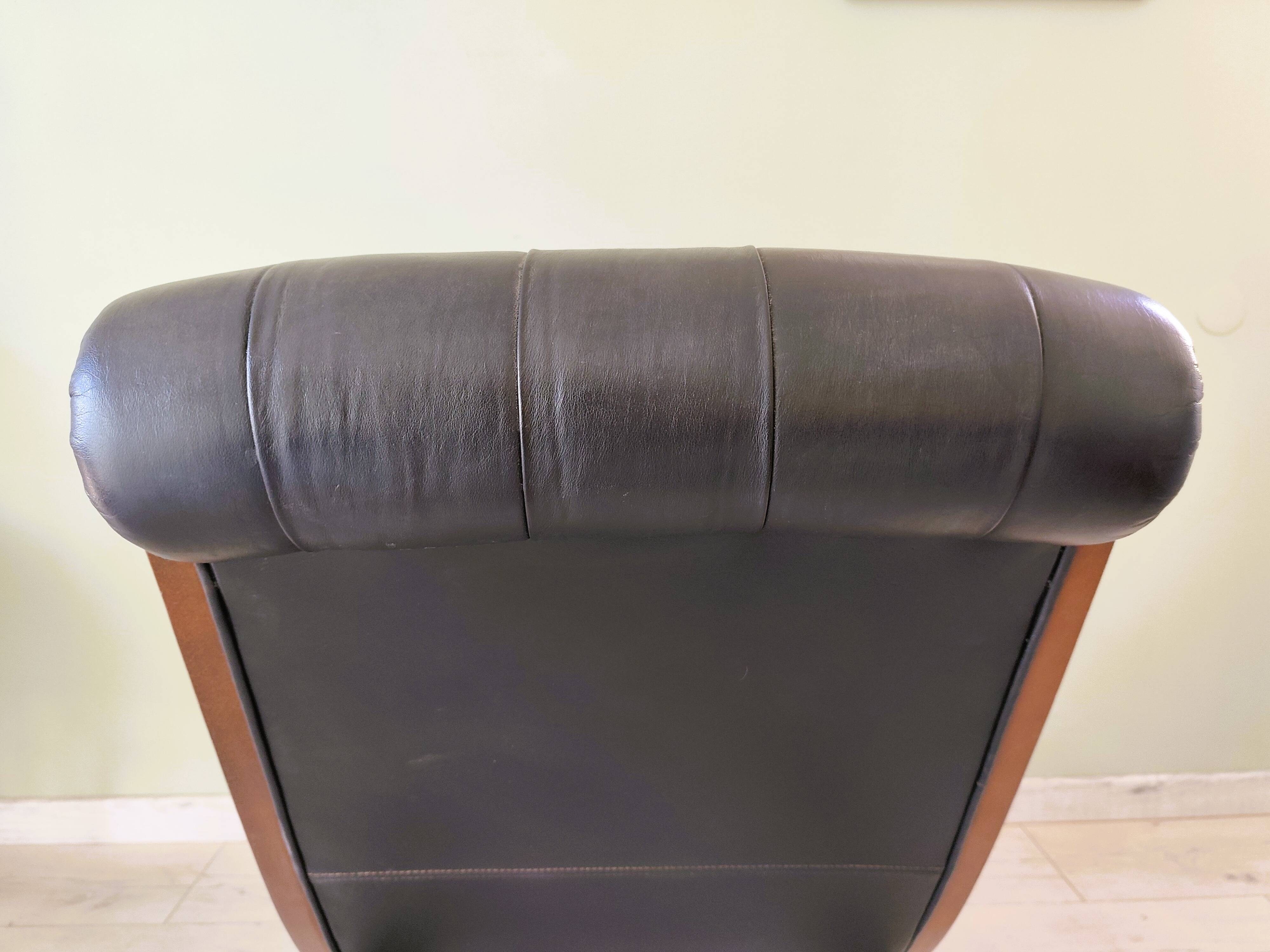 Black leather rocking Chesterfield armchair