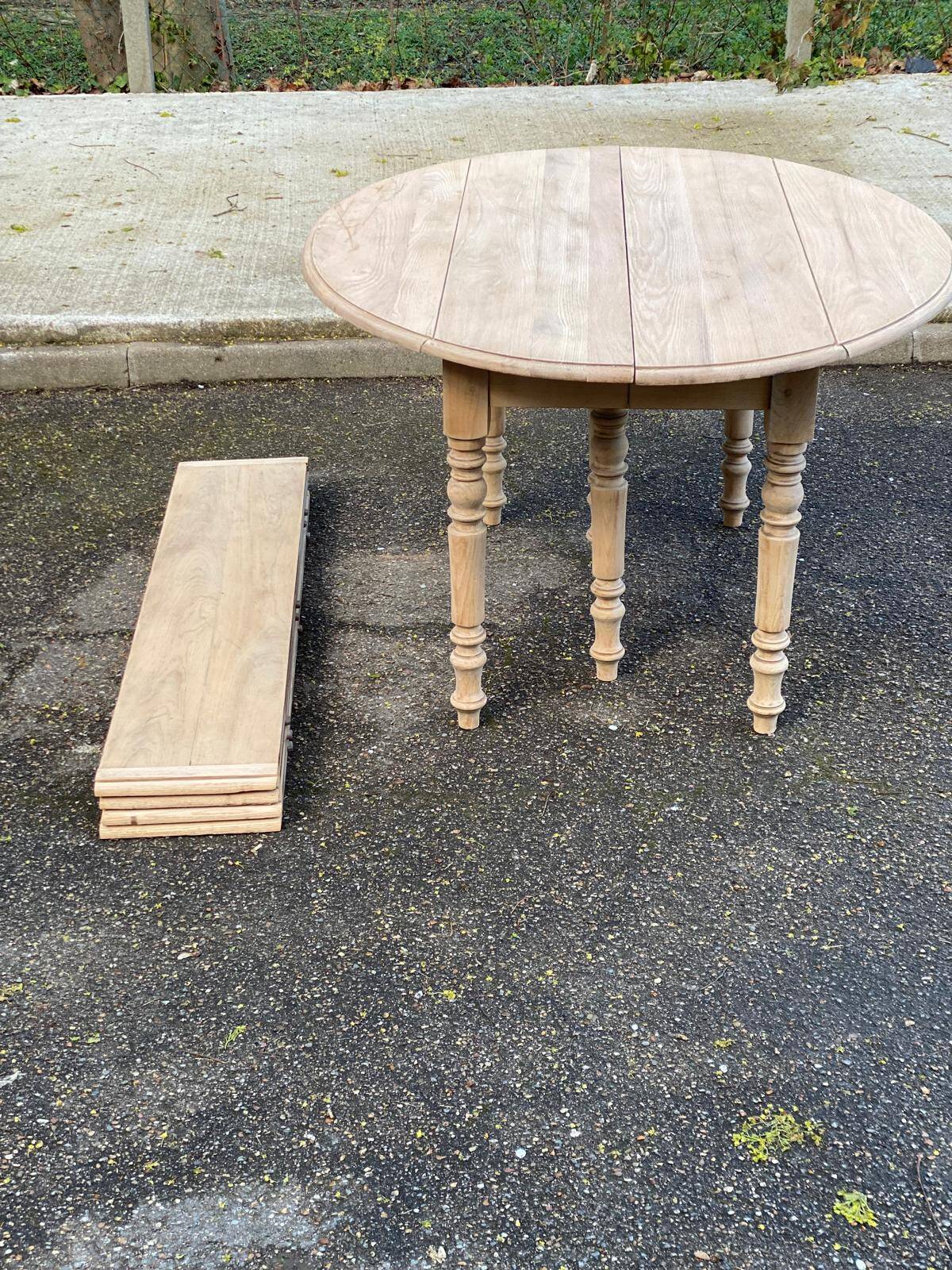 Renovated Louis Philippe round extendable dining table with 4 leaves.