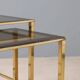 Nested tables in brass and smoked glass.