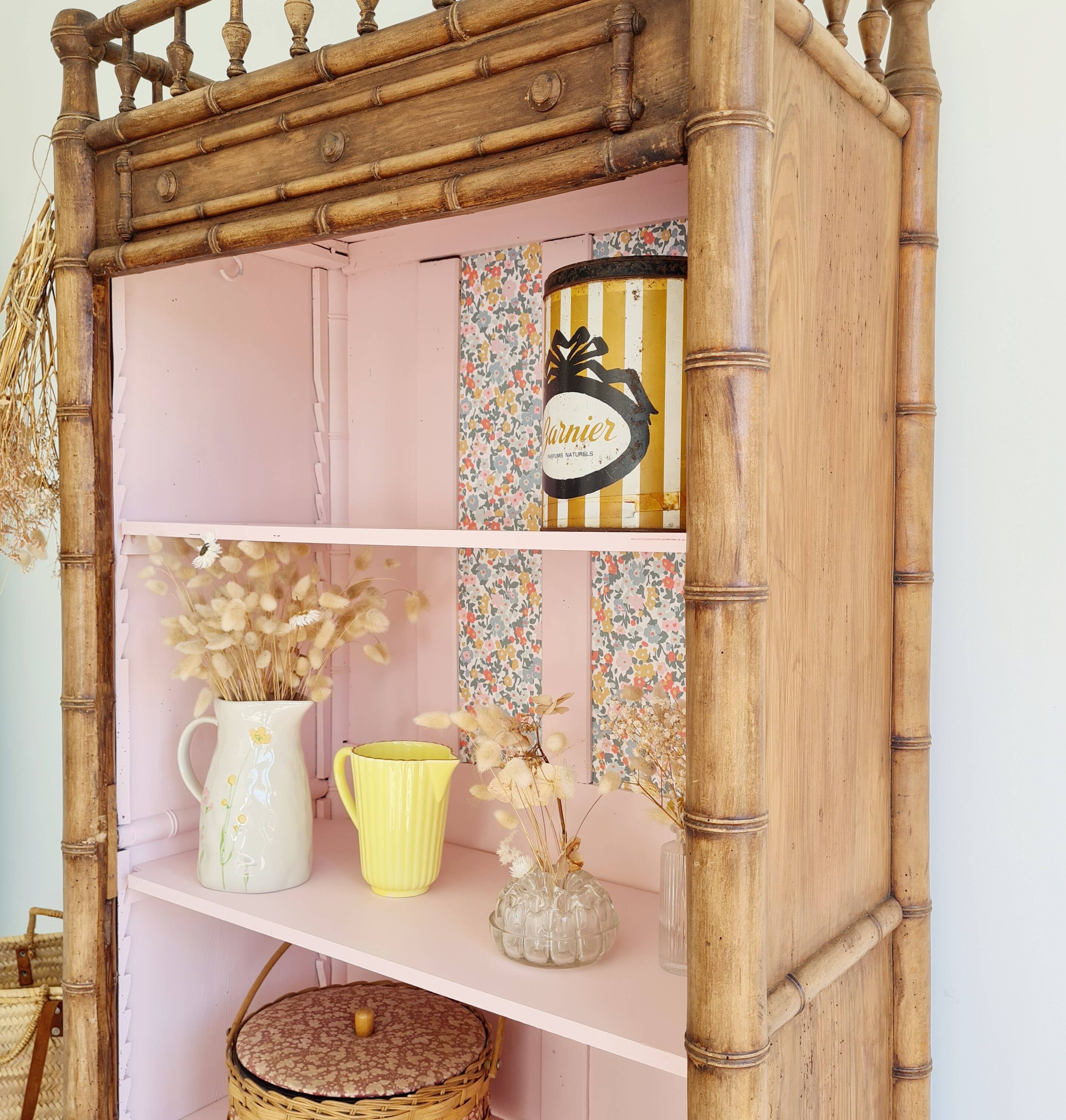 Library, old wooden cabinet imitating bamboo painted in pink