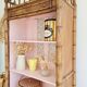 Library, old wooden cabinet imitating bamboo painted in pink