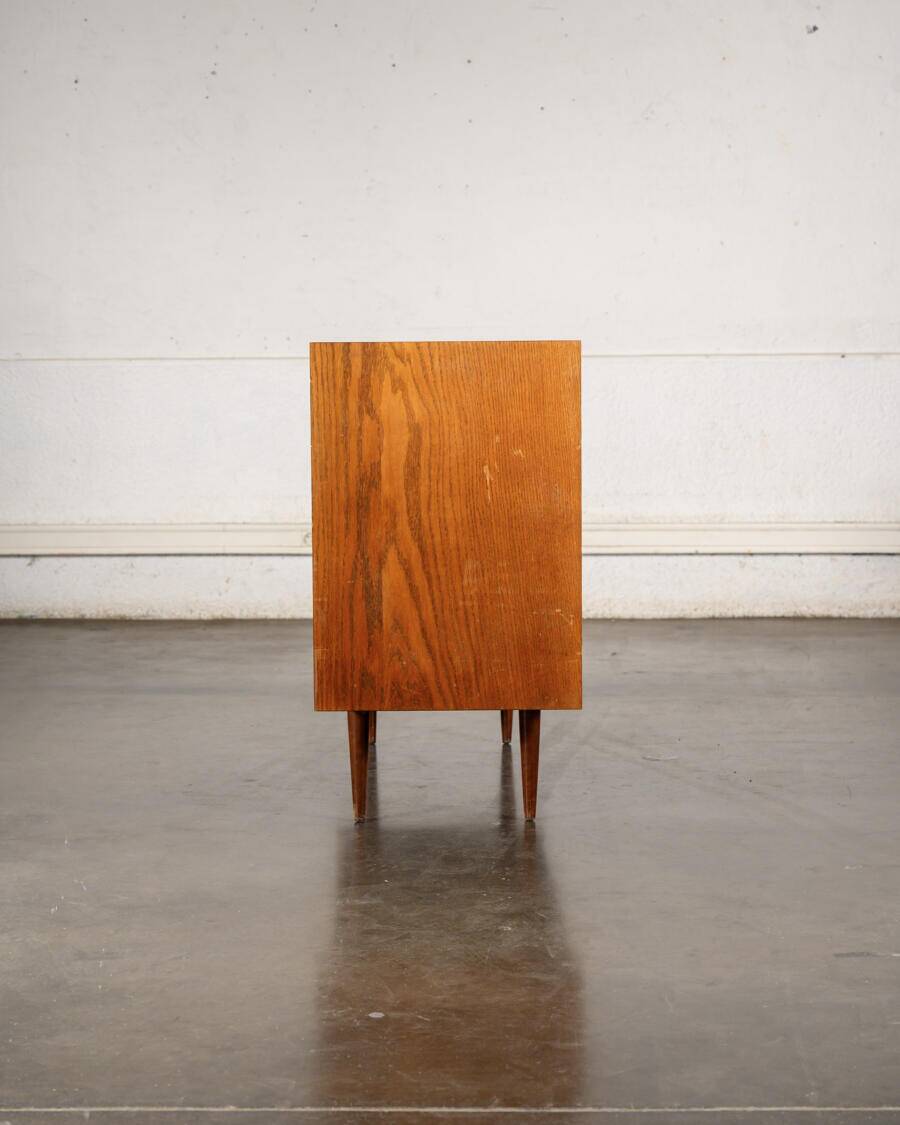 Old TV cabinet with brass handles.