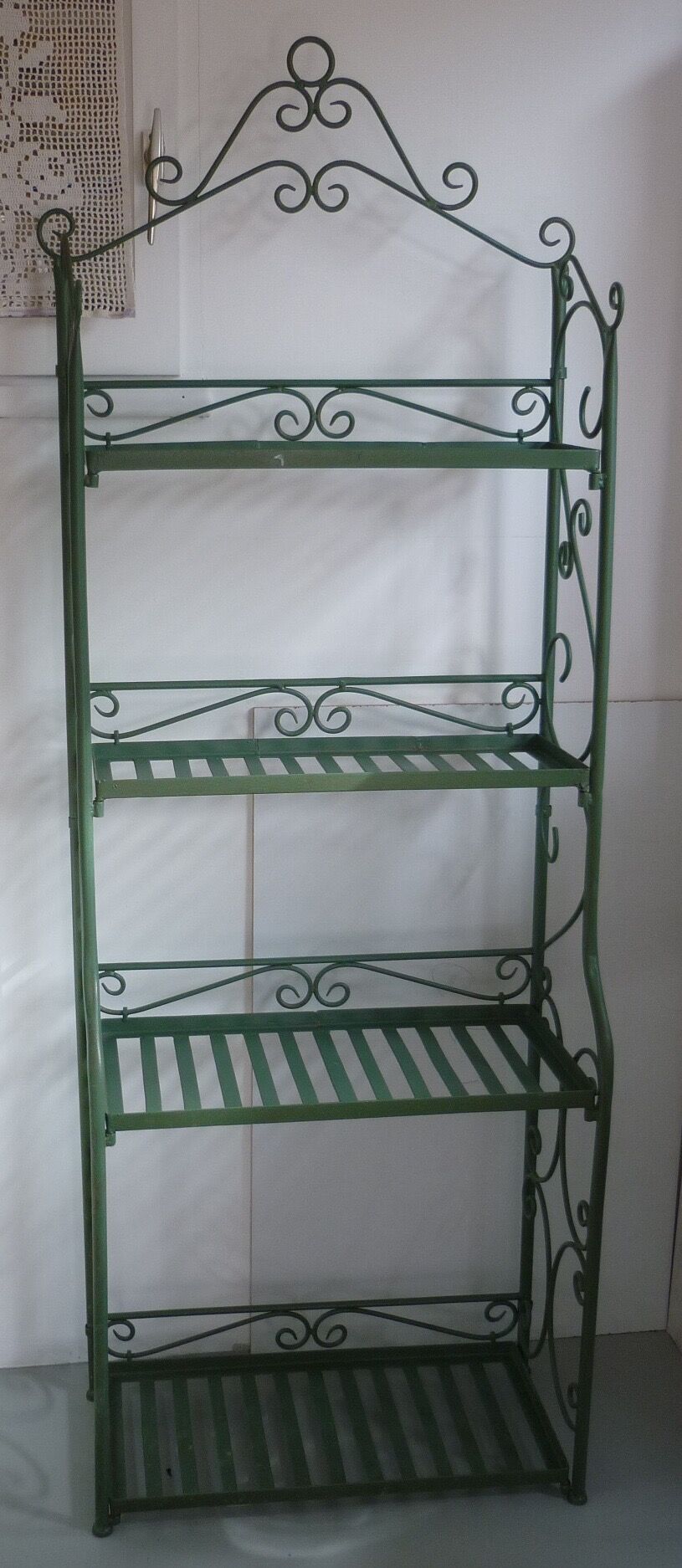 Folding green wrought iron shelf