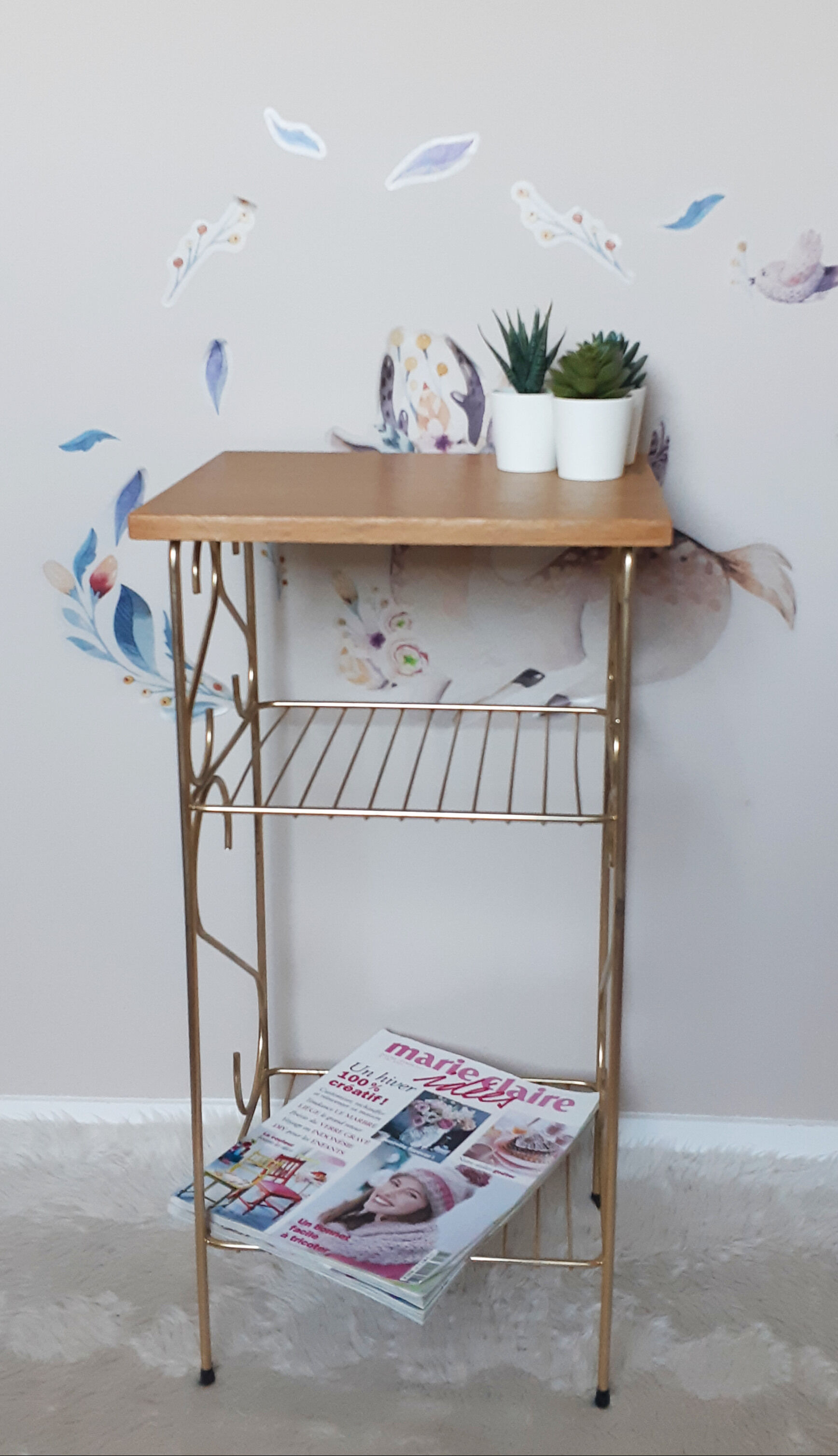 Side table with a golden magazine holder