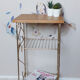 Side table with a golden magazine holder