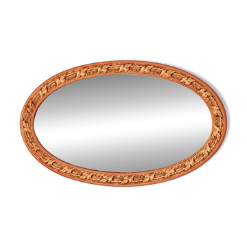 Oval mirror with a gold and ornate frame