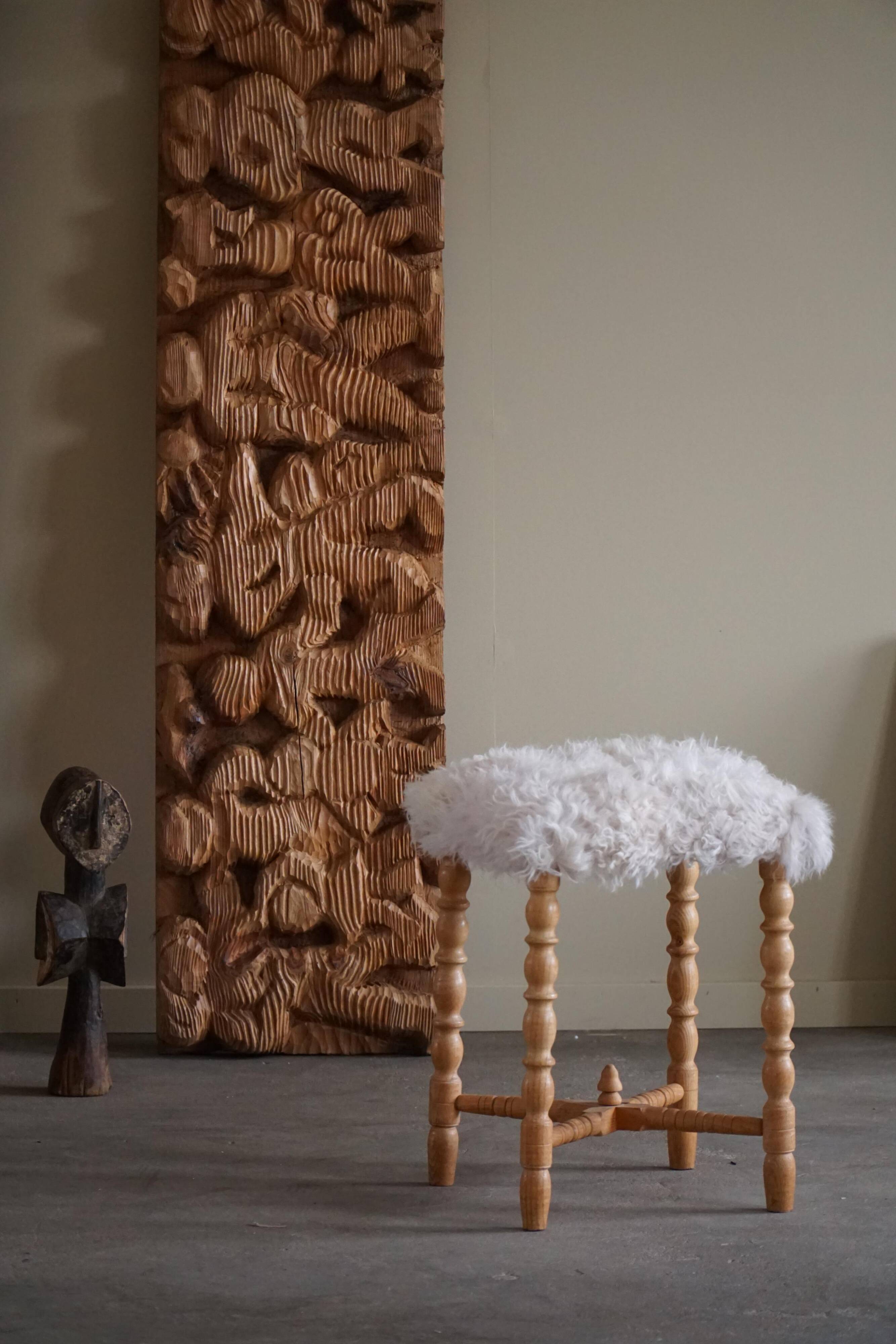 High oak stool, reupholstered in lambswool, Danish cabinetmaker, 1950s.