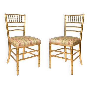 Pair of golden wood chairs in a bamboo style.