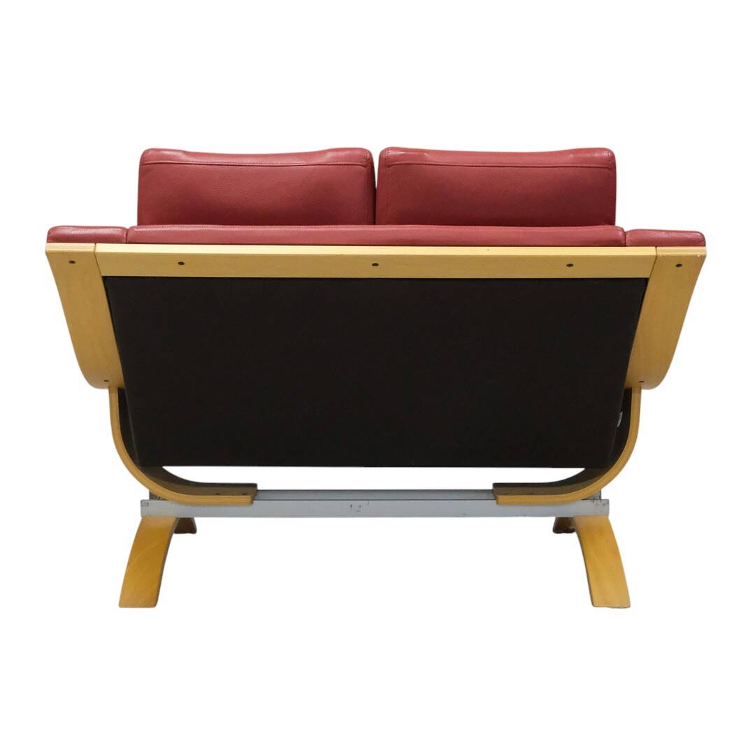 Two-seater red leather sofa by Roche Bobois on a bent beech base, France.
