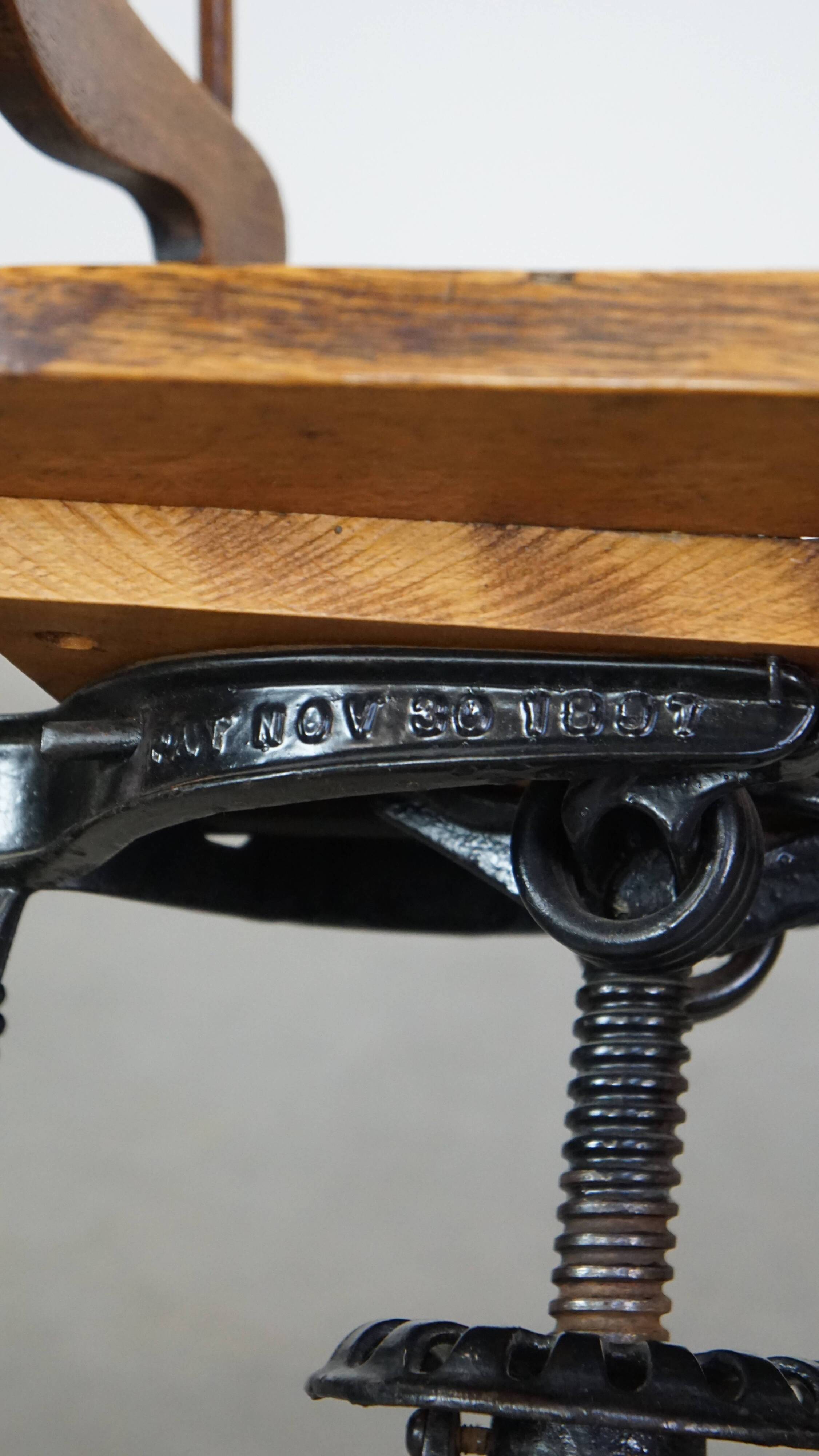 Antique late 19th century English office chair with reclining backrest and height adjustable