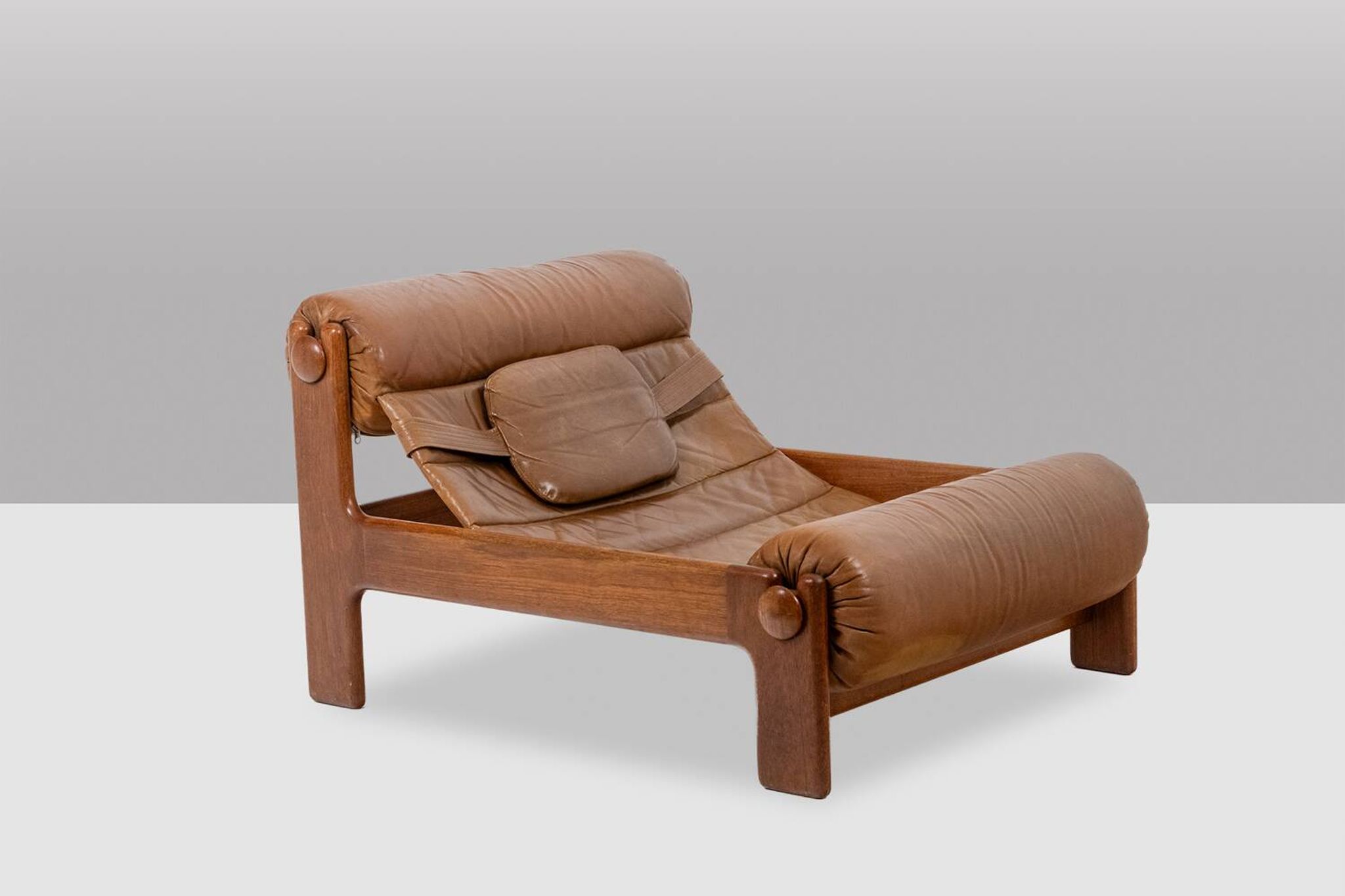 Lounge chair and ottoman, in blond elm and leather. 1970s