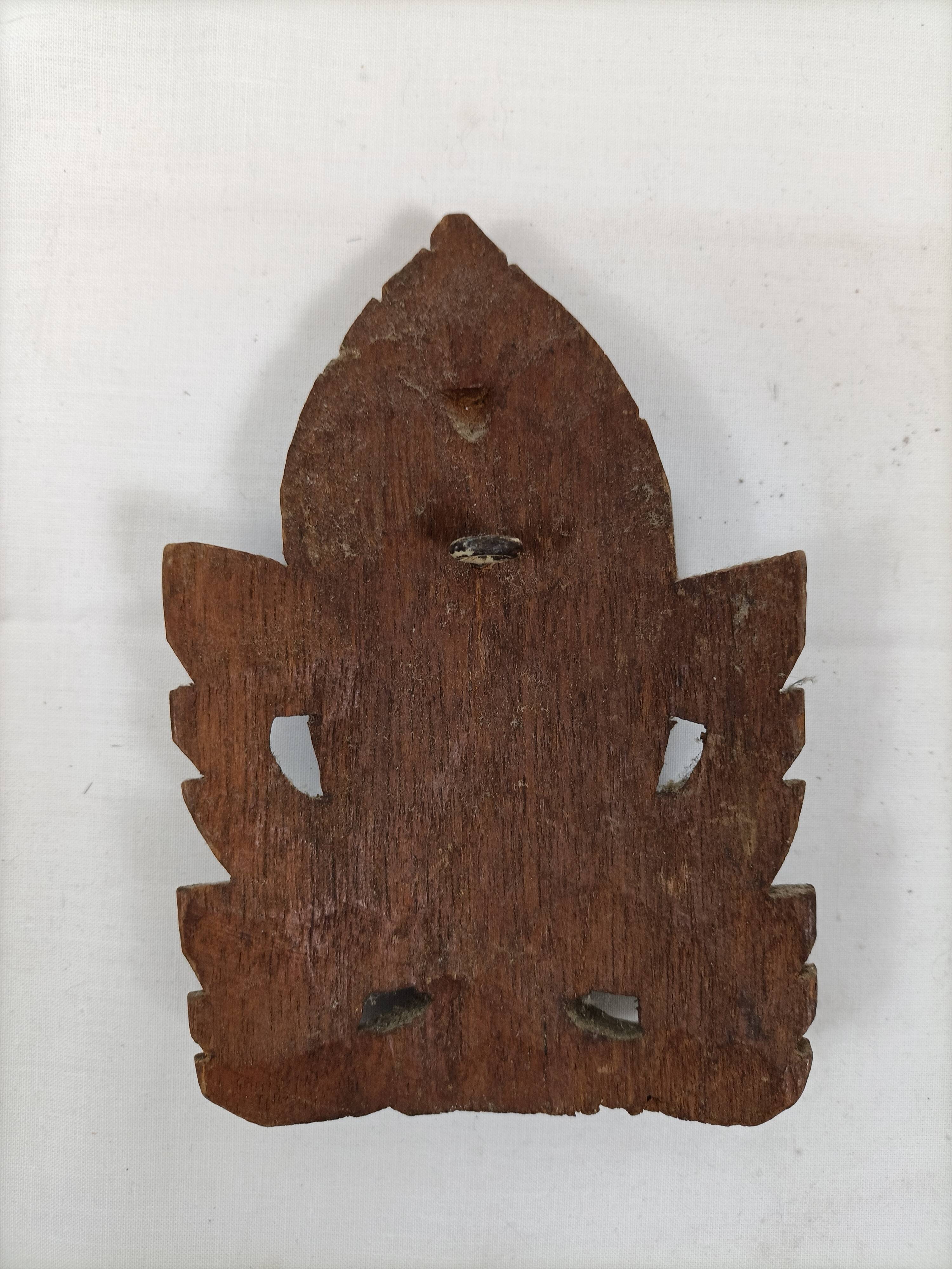 Asian decorative mask in carved wood