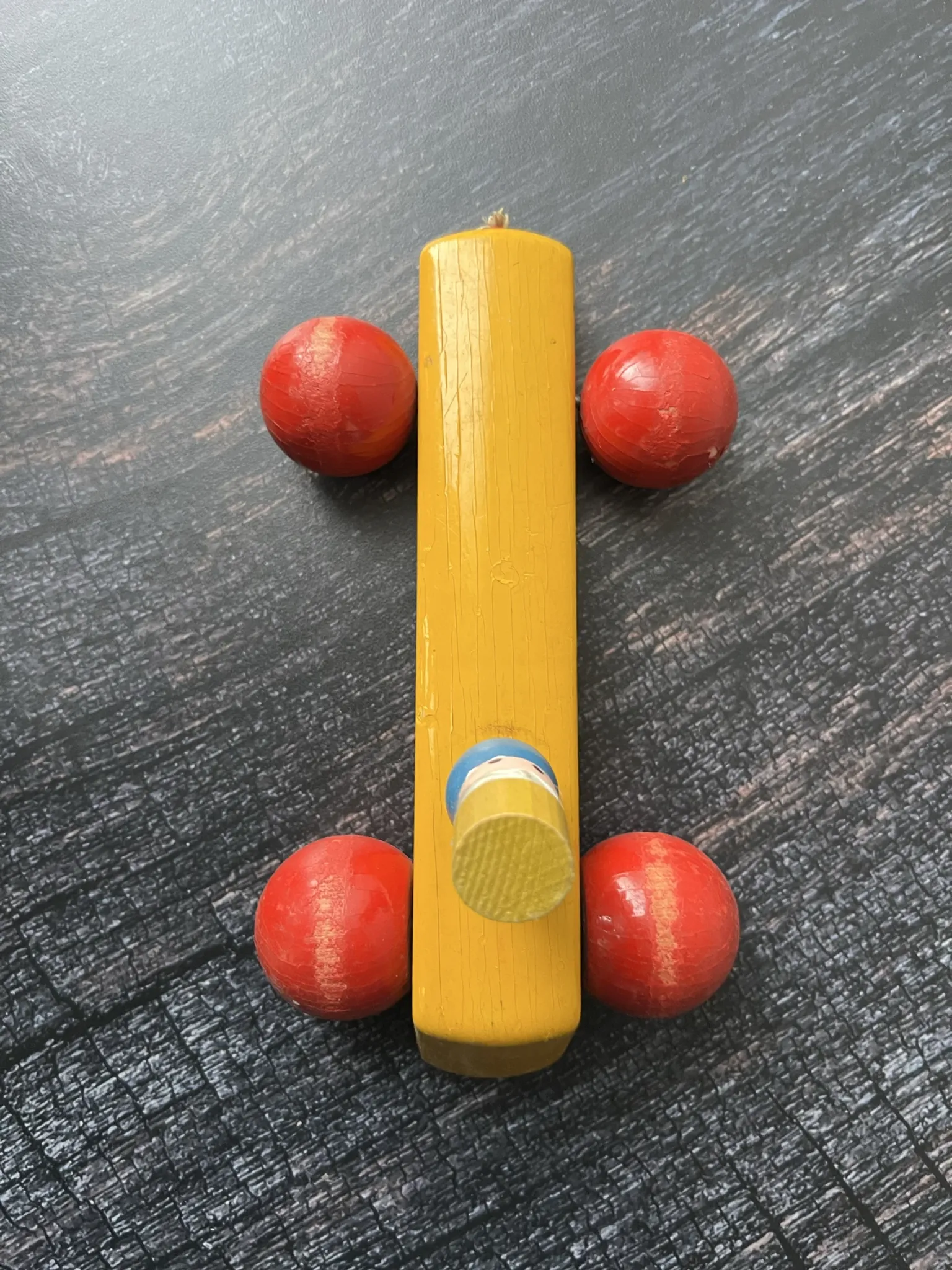Vintage wooden pull toy, yellow car and small soldier.