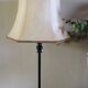 Table lamp with a patinated base and vintage woven shade.