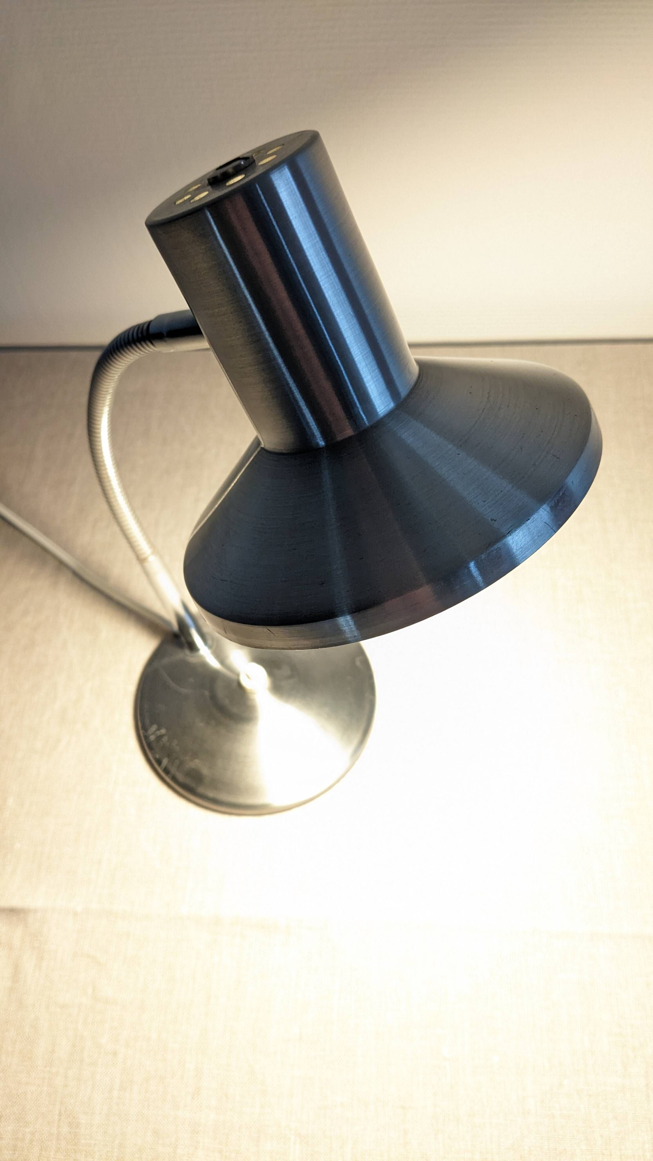 Articulated bedside lamp or wall light in aluminium, France circa 1960.