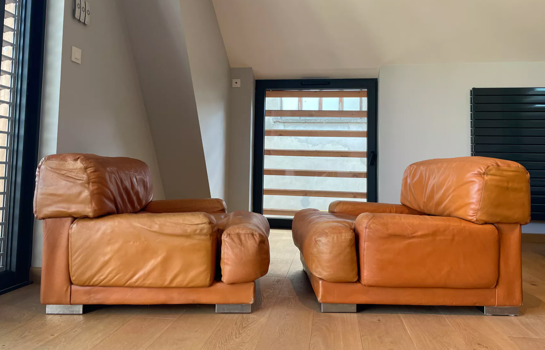 Pair of vintage armchairs Gérard Guermonprez tawny leather and stainless steel, France 1970