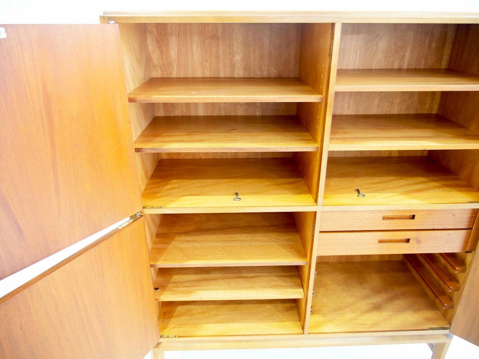 Large Swedish mahogany storage unit with four front doors.