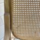 Rocking chair with a cane seat and backrest.