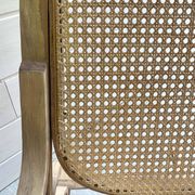 Rocking chair with a cane seat and backrest.
