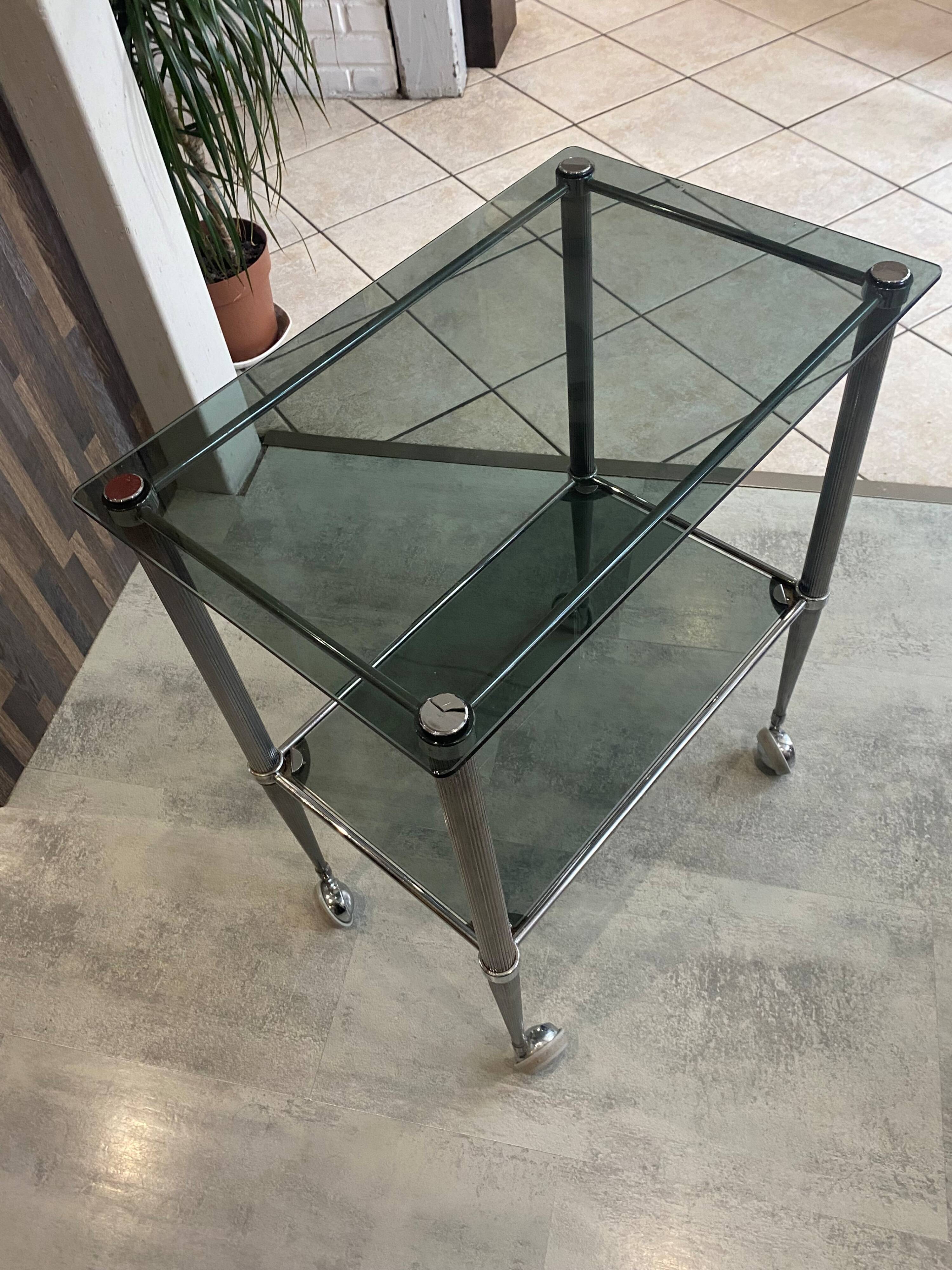 Serving dessert trolley with 2 smoked glass shelves and metal structure.