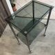 Serving dessert trolley with 2 smoked glass shelves and metal structure.