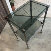 Serving dessert trolley with 2 smoked glass shelves and metal structure.