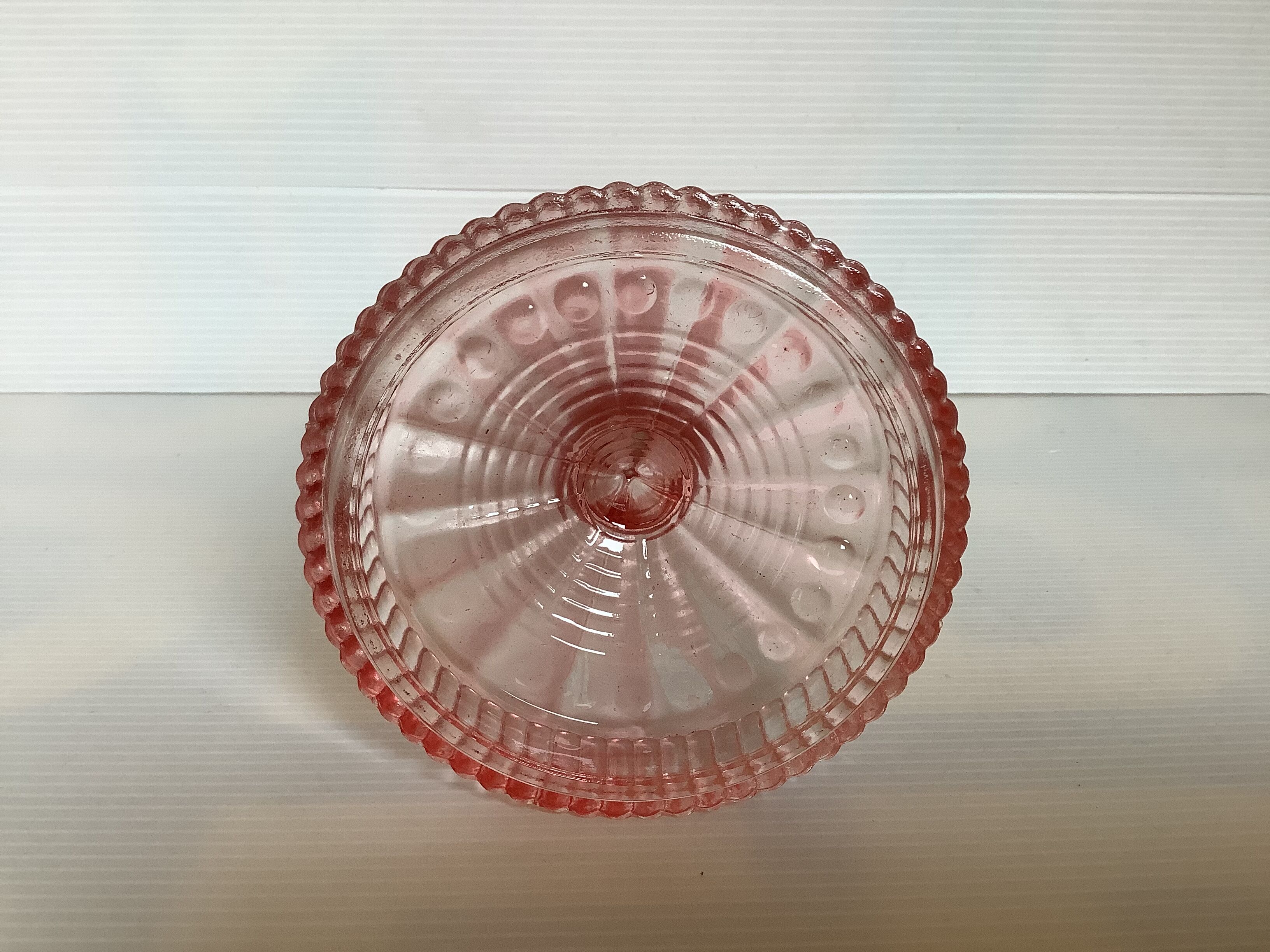 Old pink glass candlestick in Rosaline style.