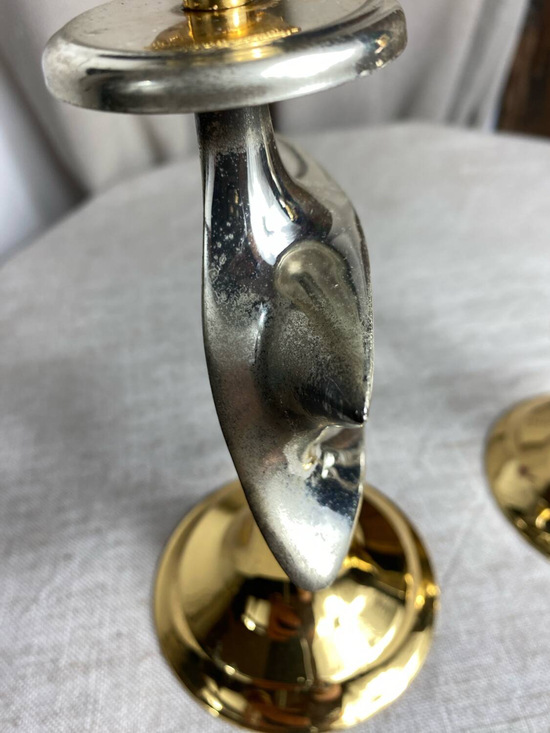Pair of silver and gold metal candlesticks