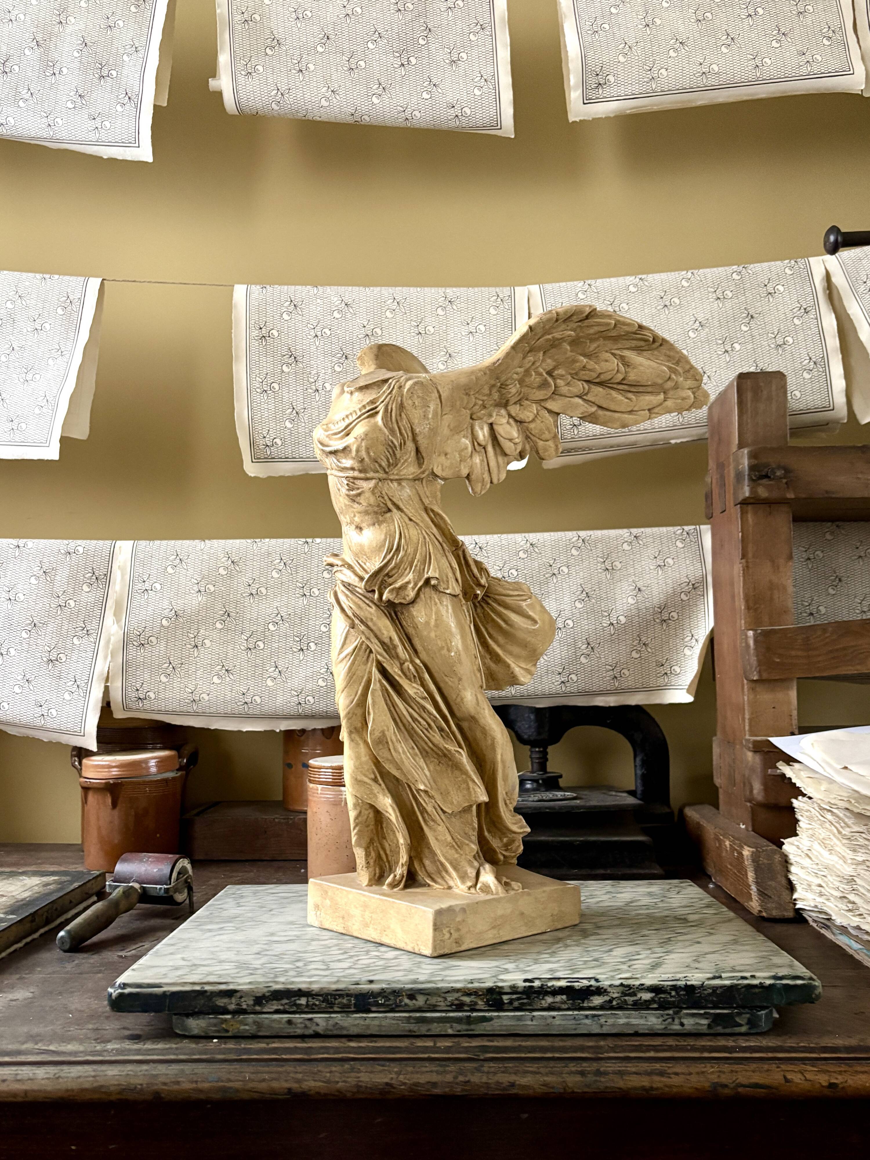 "Winged Victory of Samothrace", beige plaster statuette