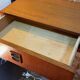 Suspended teak bedside tables in vintage 1960s Scandinavian style.