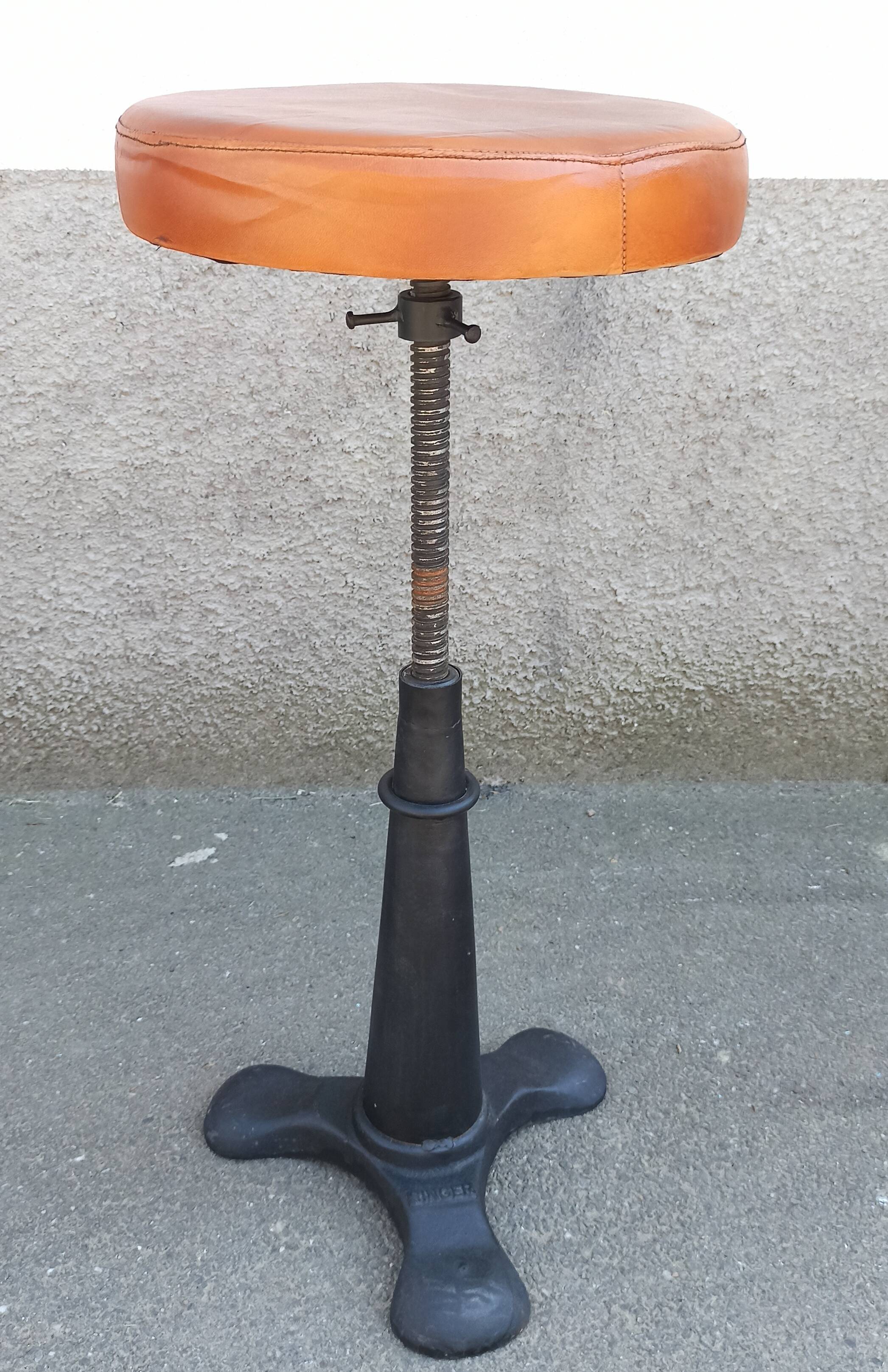 Height-adjustable leather stool with cast iron base
