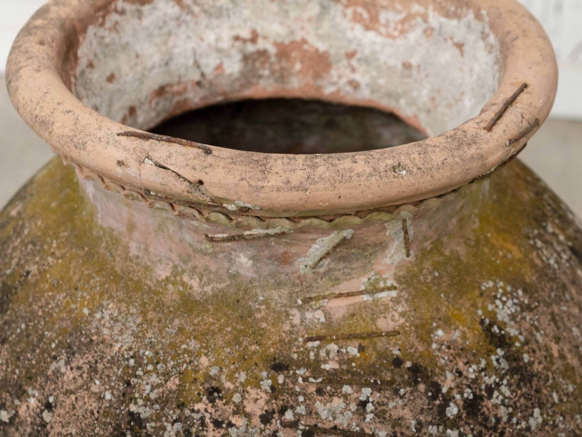 Old terracotta jar with its metal clasps, late 19th century.