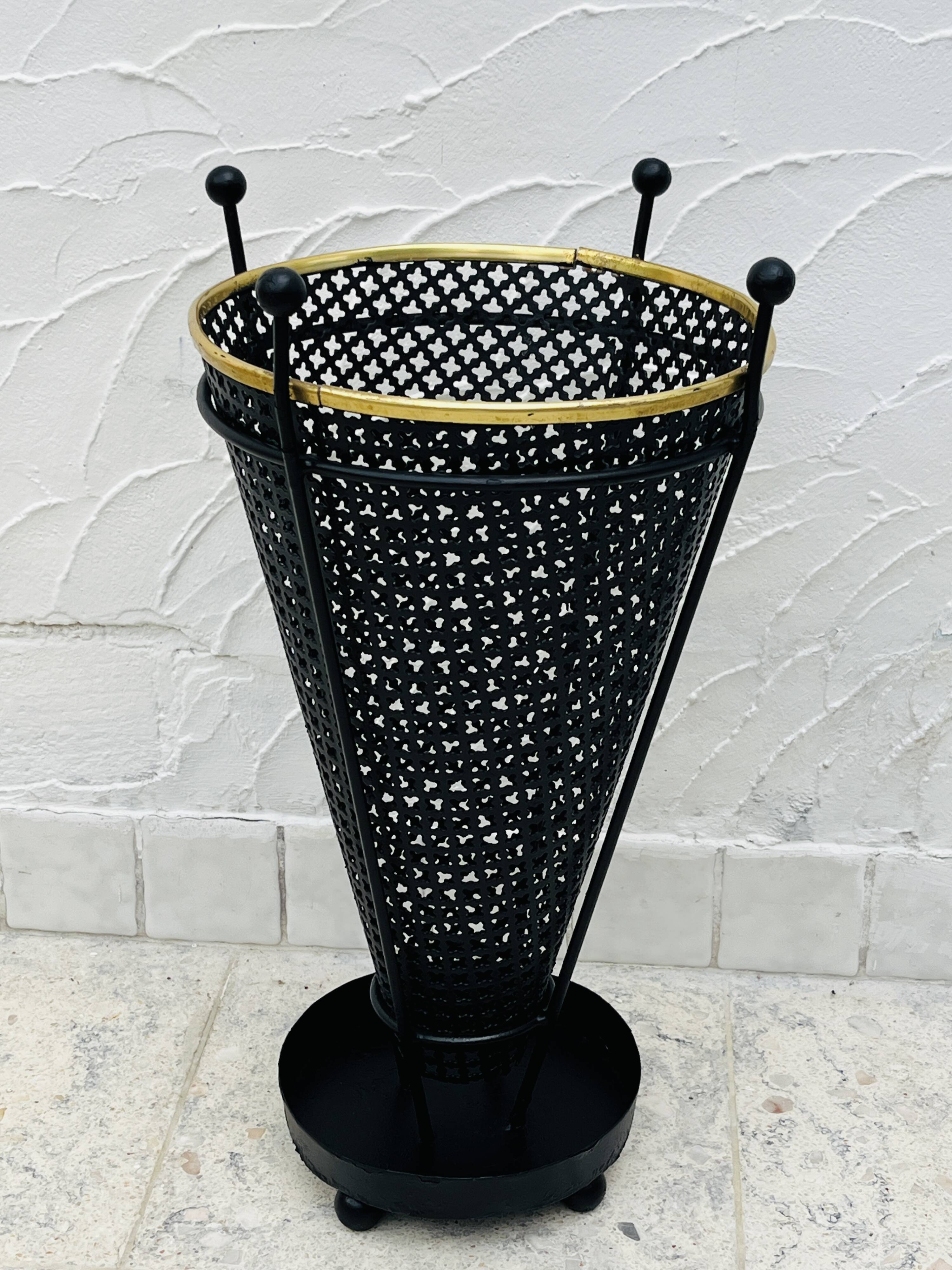 Vintage black perforated metal and brass umbrella stand