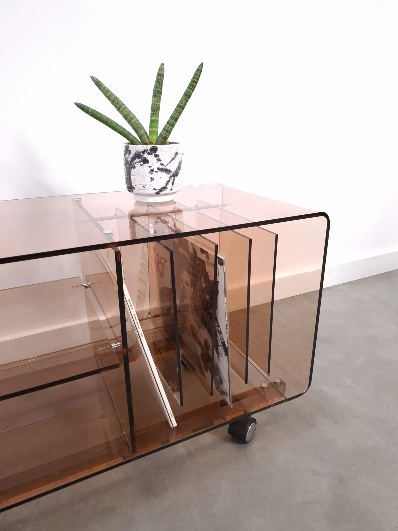 Vintage hifi, LP cabinet, TV unit made of tinted plexiglass on wheels, records.