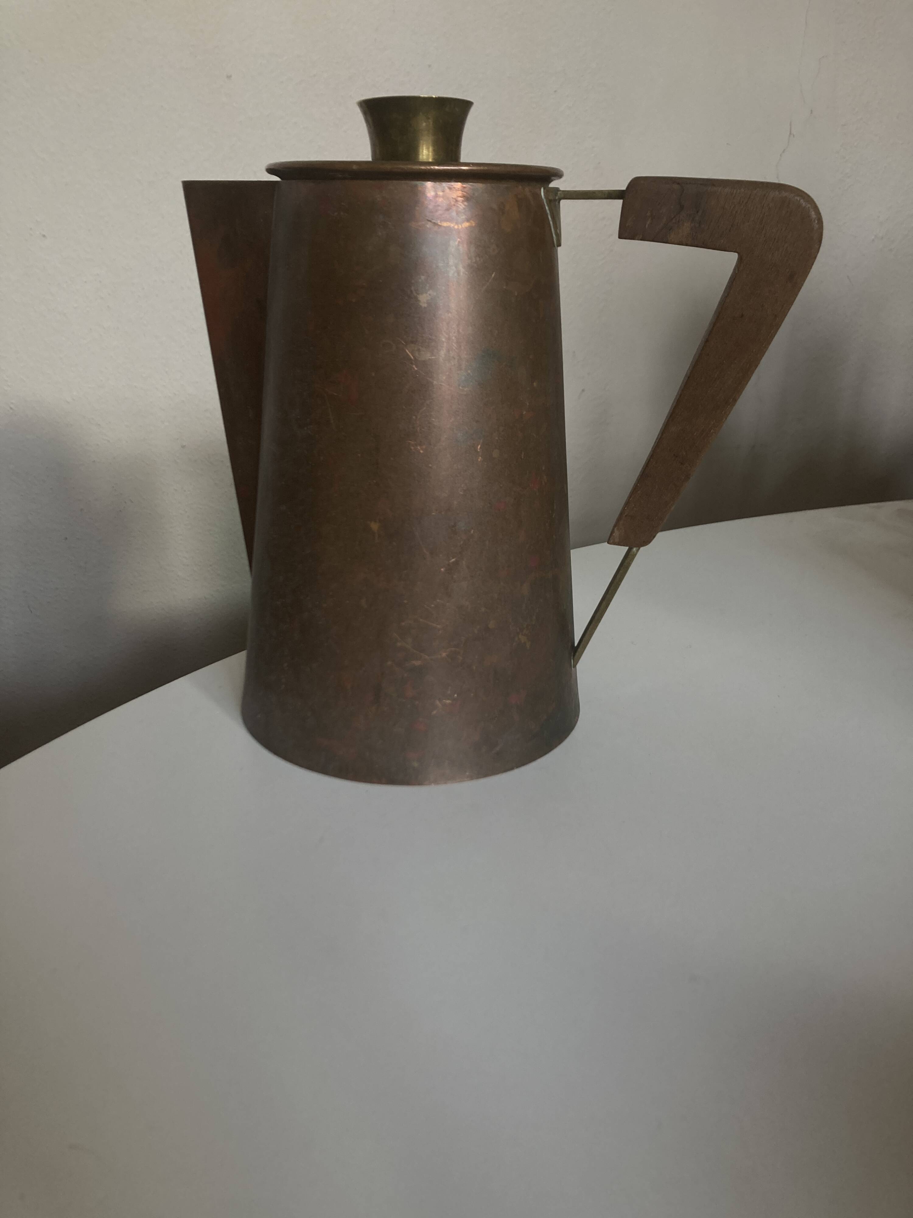 Modernist Italian pitcher design from the 1960s in patinated wood and metal.