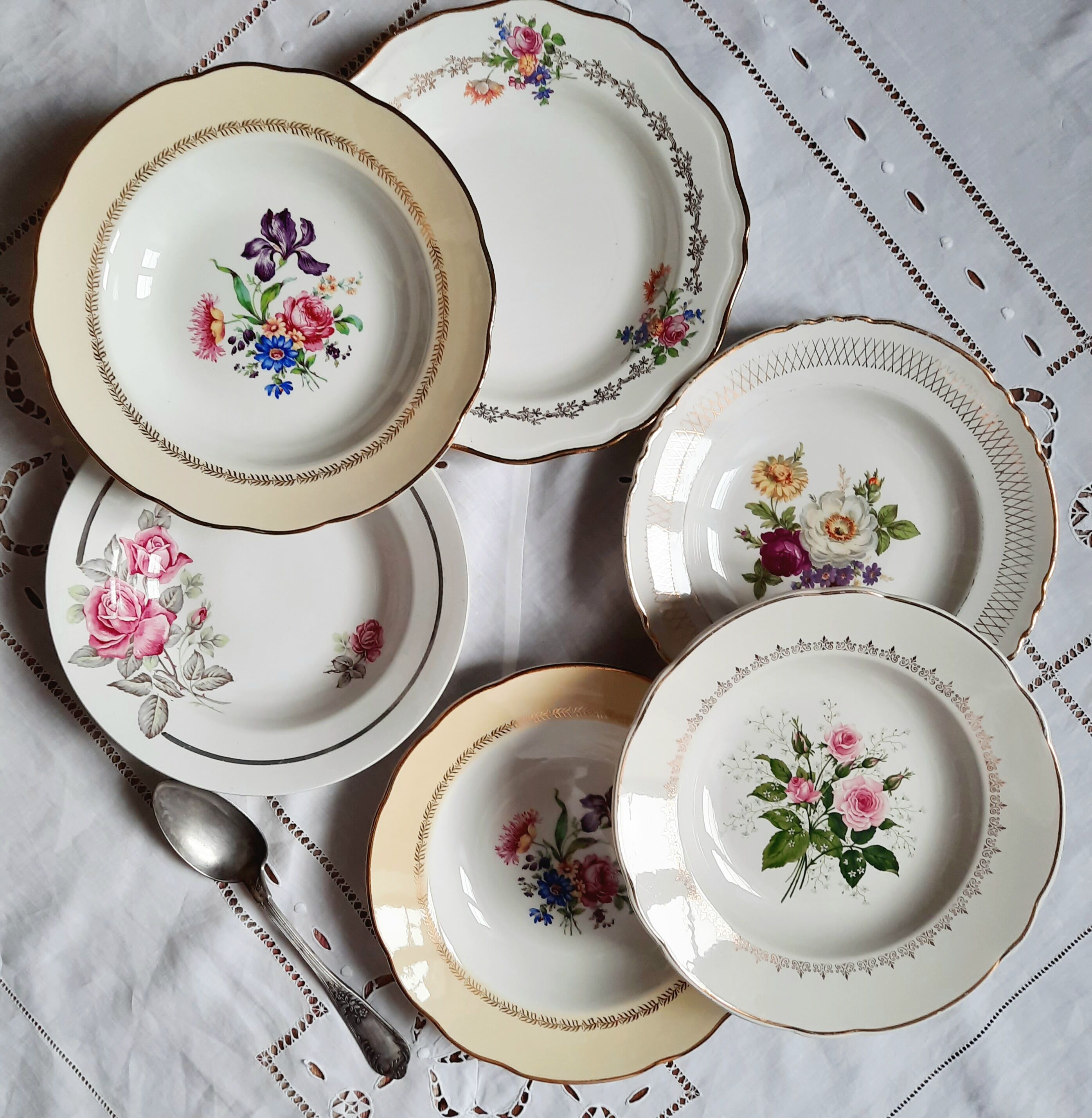 Old hollow plates mismatched in earthenware with gilded edges