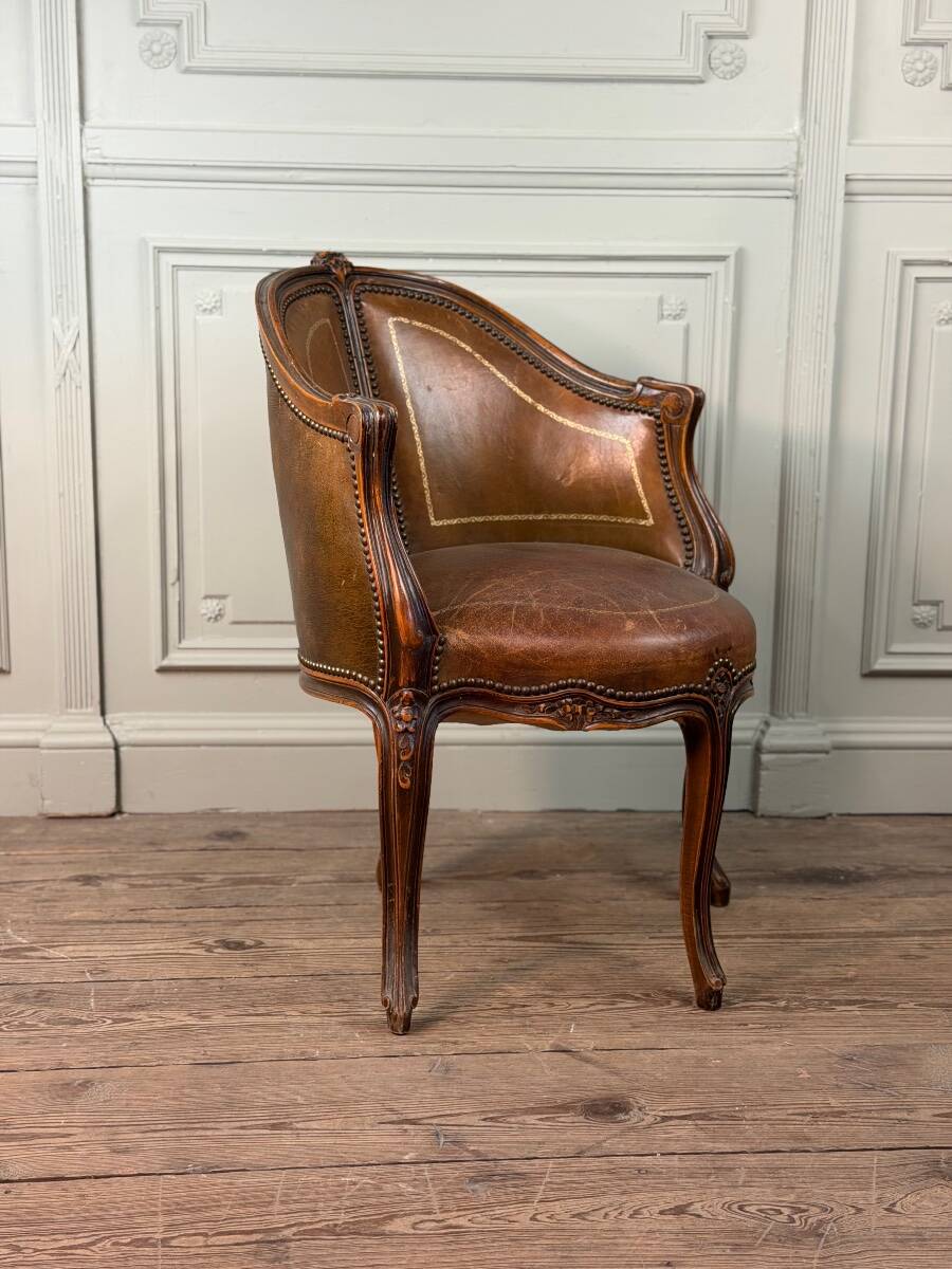 Louis XV style office chair in carved wood, brown leather, circa 1920.