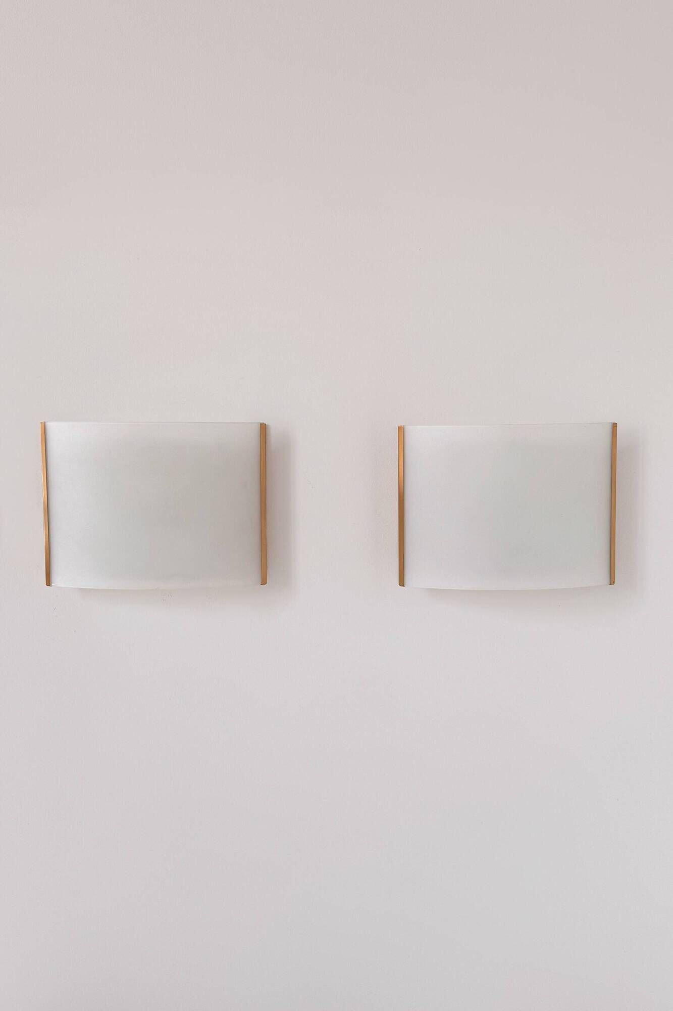Pair of vintage brass and curved glass wall lights, France, 1970.