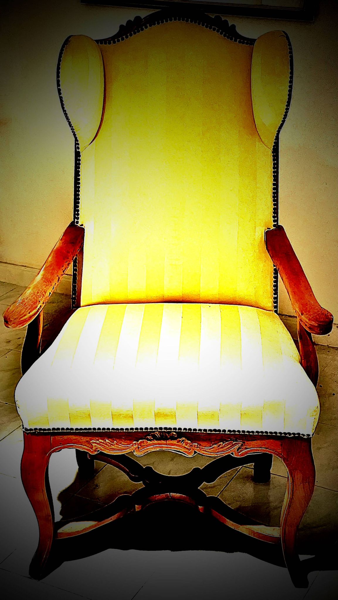 Wingback armchair in walnut in the French Regency style with stretcher in