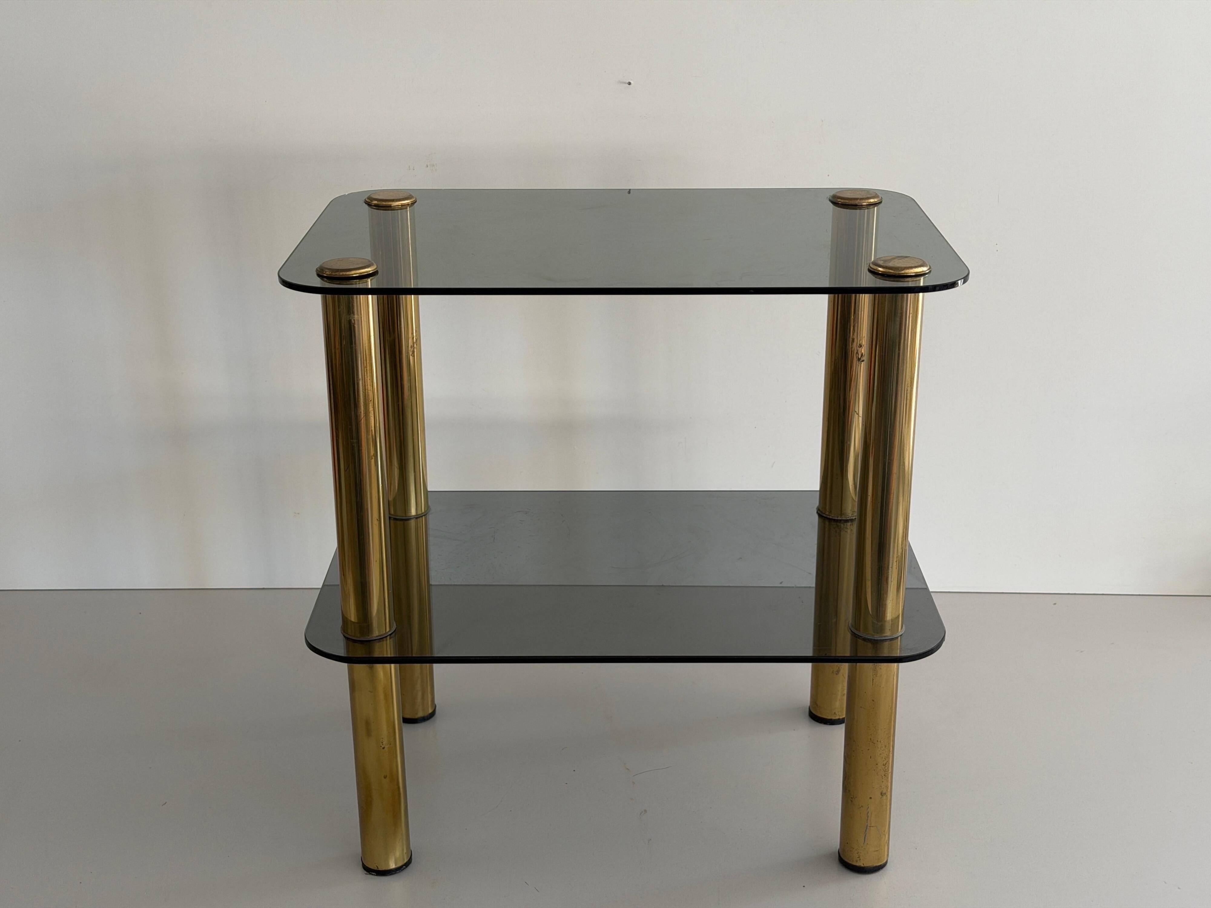 Side table in thick greenish glass with brass legs, Italy, 1960s.