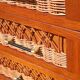 Rattan and wood splayed-leg chest of drawers