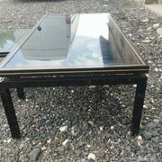 Vintage metal coffee table with glass top.