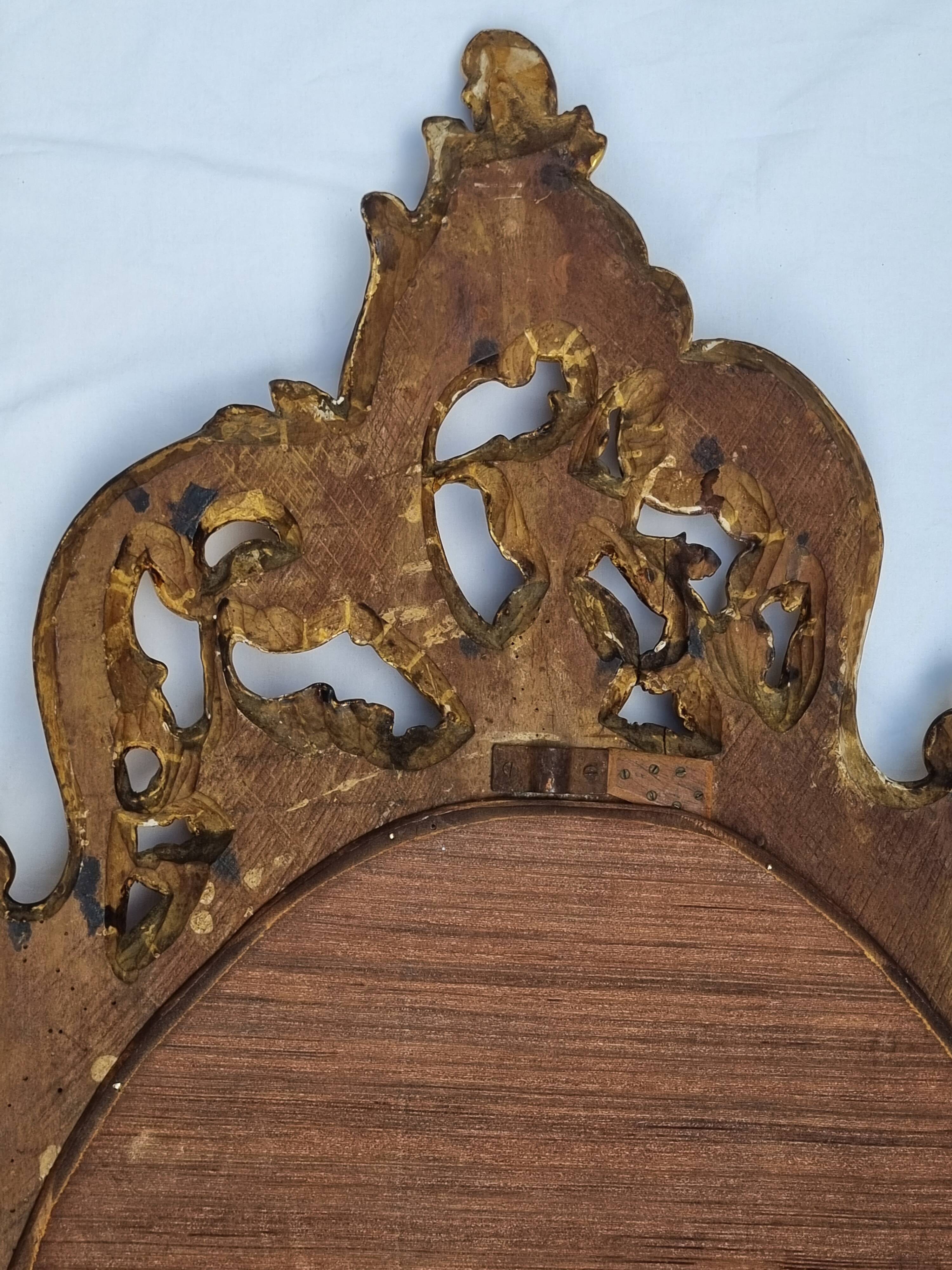 Large oval gold mirror, Louis XV rococo style, late 19th century, 114 x 66 cm.
