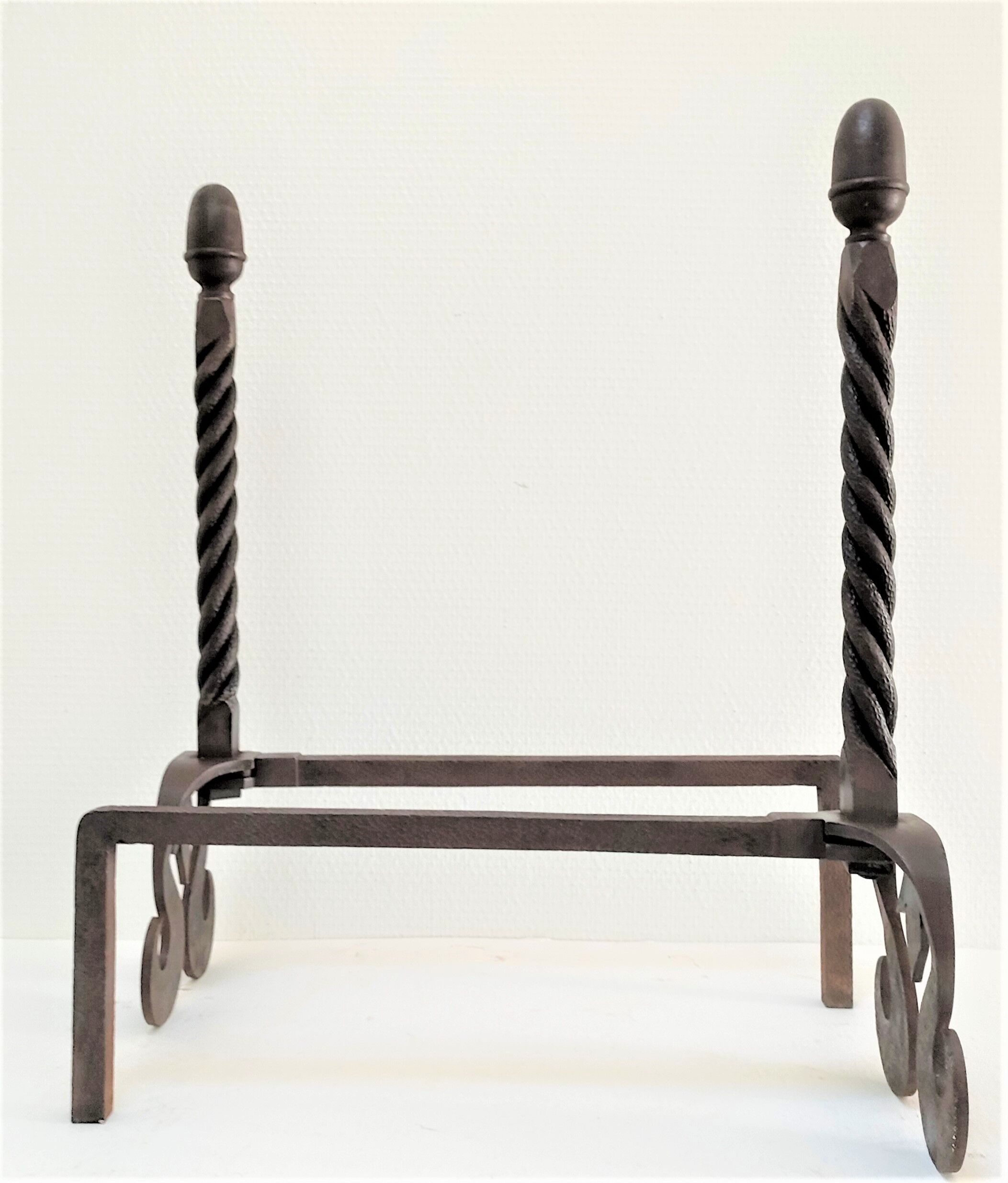 Pair of sculptural cast iron chenets with twisted heads